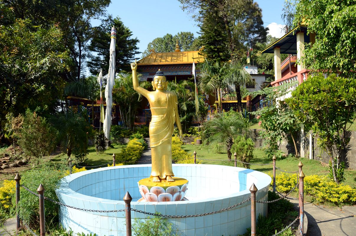 Pokhara Karma Dubgyu Chokhorling Monastery 02 Buddha Statue With Arm In The Air Welcomes You To The Garden At The Entrance Pathway 